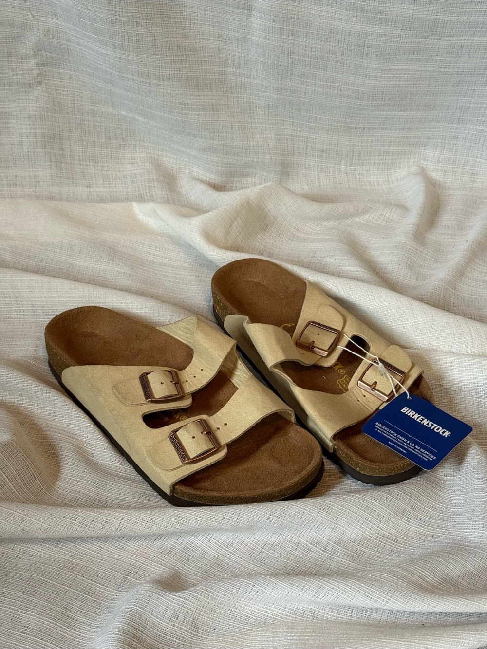the Birkenstock Arizona suede slide sandals in sandcastle